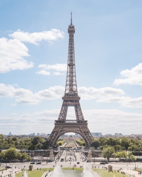 Beautiful daytime view of the Eiffel Tower in Paris, France capturing its grandeur and surroundings.