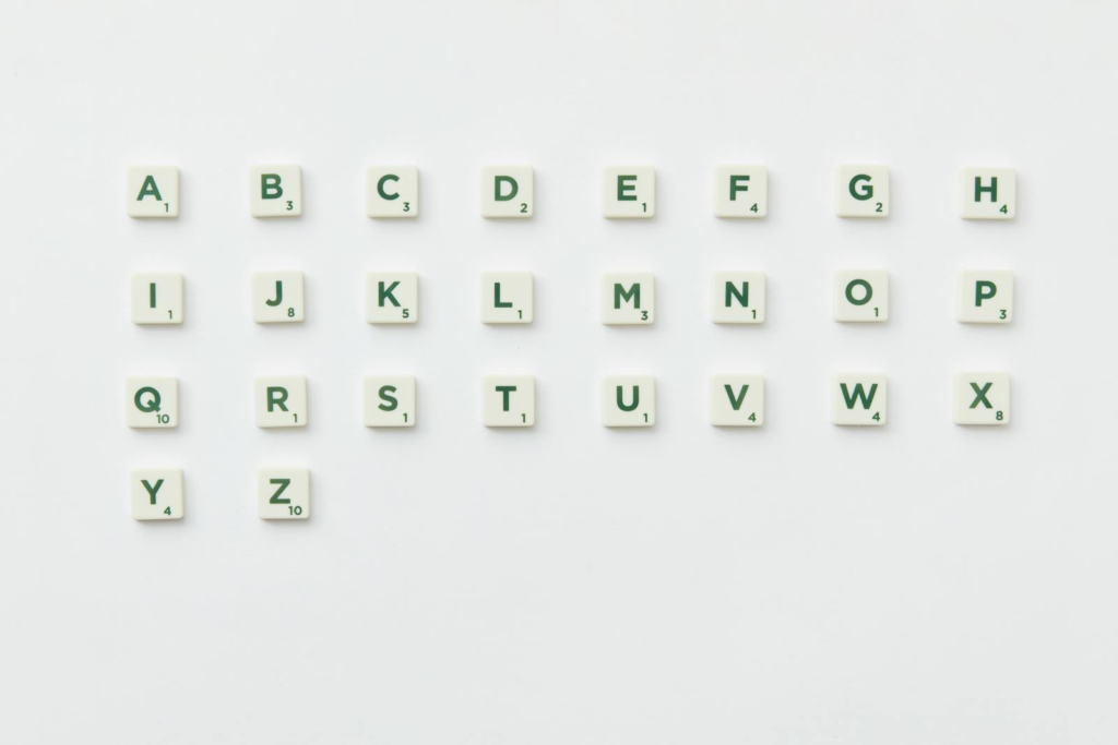 Scrabble tiles arranged alphabetically on a clean white background in a top view layout.