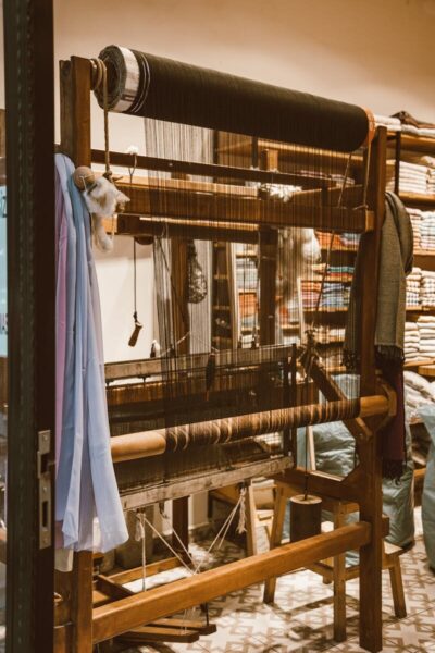 A traditional wooden loom used for weaving textiles in an artisan workshop setting.