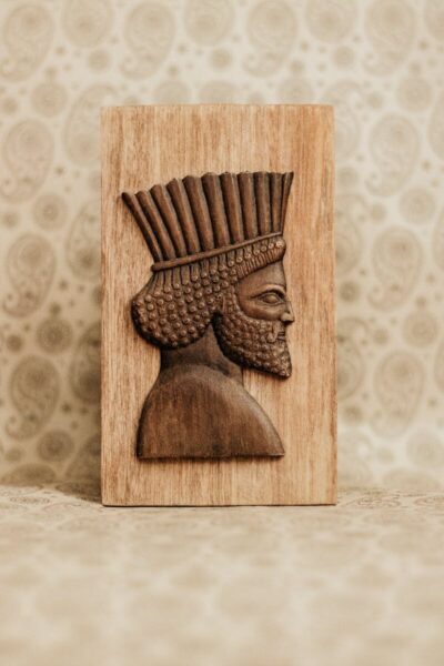 Elegant carved wooden art piece depicting ancient Persian style, perfect for decoration and cultural themes.